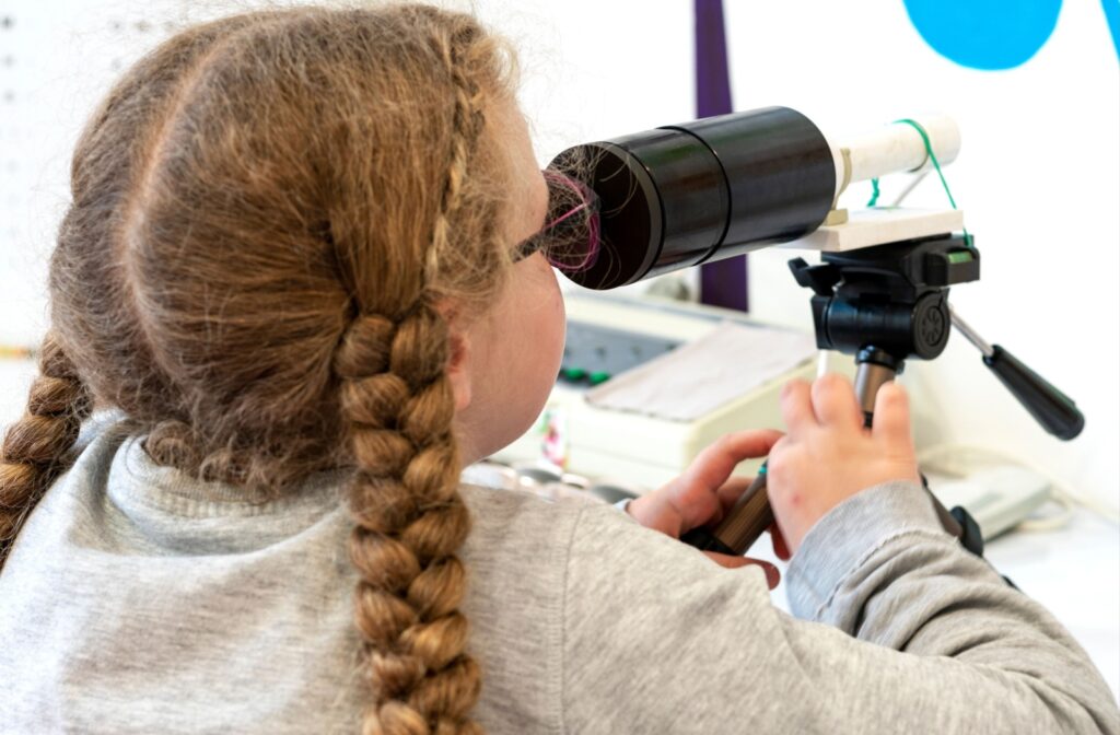 A young girl doing a vision therapy exercise.