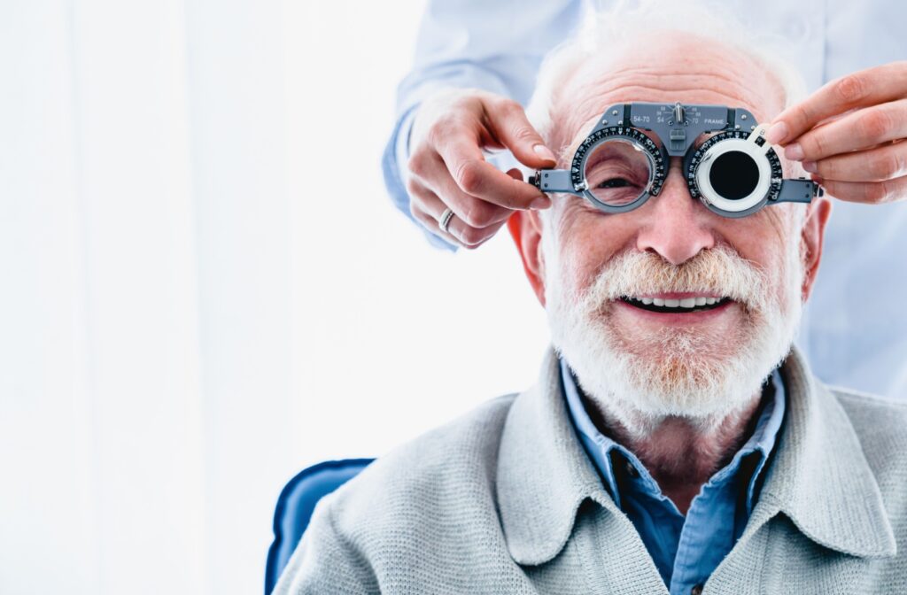 An older adult patient being fit for prescription glasses while waiting for cataract surgery.